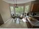 Cozy breakfast nook with tile floor, lots of windows, and nature views at 27 Creeks Edge Ct, Durham, NC 27713