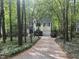 View of the home, showing the driveway and surrounding trees at 27 Creeks Edge Ct, Durham, NC 27713