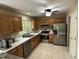 Well-lit kitchen features stainless steel appliances, and plentiful wood cabinetry at 27 Creeks Edge Ct, Durham, NC 27713