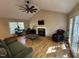 Inviting living room with hardwood floors, vaulted ceiling, fireplace, and natural light at 27 Creeks Edge Ct, Durham, NC 27713