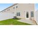 A fenced backyard and back of a house with a door and a small patio at 2836 Egert Dr, Haw River, NC 27258