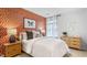Stylish bedroom featuring a vibrant wallpaper accent wall, large bed, and modern decor at 2836 Egert Dr, Haw River, NC 27258