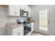 Modern kitchen featuring white cabinets, stainless steel appliances, and plenty of counter space at 2836 Egert Dr, Haw River, NC 27258