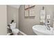 Stylish powder room features a modern vessel sink, neutral walls, and elegant botanical prints at 2836 Egert Dr, Haw River, NC 27258