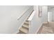 Carpeted staircase featuring a white banister, leading to the upper level of the home at 2836 Egert Dr, Haw River, NC 27258