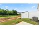 Backyard featuring a white fence bordering a green space and a small concrete patio at 2838 Egert Dr, Haw River, NC 27258