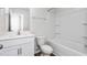 Bathroom featuring a white vanity, toilet, and shower-tub combo with white tile surround at 2838 Egert Dr, Haw River, NC 27258