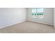 This bedroom features a window offering lots of natural light and neutral carpeting at 2838 Egert Dr, Haw River, NC 27258