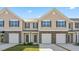 Townhome exterior with stone accents, individual garages, and manicured lawns showcases modern curb appeal at 2838 Egert Dr, Haw River, NC 27258