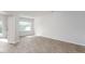Bright living room with modern flooring, large windows, and a neutral color palette for versatile decorating at 2838 Egert Dr, Haw River, NC 27258