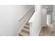 Carpeted staircase with white walls and railing, leading to an upper level and light-filled landing at 2838 Egert Dr, Haw River, NC 27258