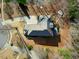 Overhead aerial view of a home showcasing the roof, driveway, landscaping, and surrounding wooded area at 3 Alumwood Pl, Durham, NC 27705