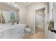 Charming bathroom with white vanity, ample lighting, and tiled flooring at 3 Alumwood Pl, Durham, NC 27705