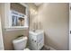 Bright bathroom featuring a white vanity, framed mirror, and a window offering natural light at 3 Alumwood Pl, Durham, NC 27705