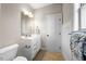 Well-lit bathroom featuring a white vanity, framed mirror, and decorative towel at 3 Alumwood Pl, Durham, NC 27705