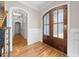 Elegant foyer with hardwood floors, wood trim, and frosted glass doors at 3 Alumwood Pl, Durham, NC 27705
