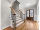 Entryway boasting hardwood floors, elegant staircase with wrought iron, and stylish lighting at 3 Alumwood Pl, Durham, NC 27705