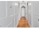 Bright hallway with hardwood floors and paneled wainscoting at 3 Alumwood Pl, Durham, NC 27705