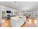 Open-concept kitchen island with stone countertop, stainless steel sink, and pendant lighting at 3 Alumwood Pl, Durham, NC 27705