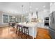 Bright kitchen features a large island, granite countertops, and stainless steel appliances at 3 Alumwood Pl, Durham, NC 27705