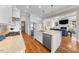 Open kitchen showcasing a center island, stainless steel appliances, and hardwood floors at 3 Alumwood Pl, Durham, NC 27705