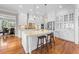 Gourmet kitchen with custom cabinets, a center island with seating, and stainless steel appliances at 3 Alumwood Pl, Durham, NC 27705