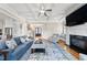 Spacious living room with hardwood floors, fireplace, and a seamless connection to the kitchen at 3 Alumwood Pl, Durham, NC 27705