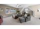 Cozy living room with comfortable seating, natural light, and neutral carpet at 3 Alumwood Pl, Durham, NC 27705