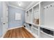 Mudroom with built in shelving, storage cubbies, and hardwood floors at 3 Alumwood Pl, Durham, NC 27705