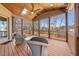 Relaxing screened-in porch with wood ceiling, skylight, ceiling fan, and comfortable seating area overlooking the backyard at 3 Alumwood Pl, Durham, NC 27705