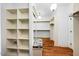 Spacious walk-in closet with custom shelving, drawers, hardwood floors, and a built-in bench at 3 Alumwood Pl, Durham, NC 27705