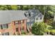 Aerial view of townhouses with gray roofs and mature trees at 3111 Coachmans Way, Durham, NC 27705