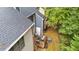 Aerial view of townhouse with a cozy deck featuring outdoor seating and surrounding trees for privacy at 3111 Coachmans Way, Durham, NC 27705