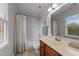 Full bathroom with vanity and tub, and shower with curtain and natural light at 3111 Coachmans Way, Durham, NC 27705
