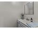 Bathroom features a vanity with a decorative mirror and a small vase of flowers at 3111 Coachmans Way, Durham, NC 27705