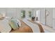 Bedroom displays soft bedding, two bright windows and an open bathroom door at 3111 Coachmans Way, Durham, NC 27705