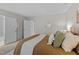 Bedroom view featuring neutral colors, comfortable bedding, and two white entry doors at 3111 Coachmans Way, Durham, NC 27705
