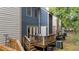 A multi-level deck featuring wood railings, an outdoor sitting area, and access to both levels of the townhouse at 3111 Coachmans Way, Durham, NC 27705