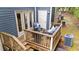 View of the deck with outdoor seating, wooden railings, and stairs leading down to the backyard area at 3111 Coachmans Way, Durham, NC 27705