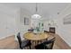Dining room with a round table and chairs, with view of fireplace and living room at 3111 Coachmans Way, Durham, NC 27705