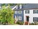 Charming townhouse with blue siding, dormer windows, and landscaped front yard at 3111 Coachmans Way, Durham, NC 27705