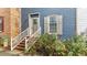 Inviting blue home entrance with brick accents and well-maintained landscaping at 3111 Coachmans Way, Durham, NC 27705