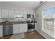 Bright kitchen with white cabinets, stainless steel appliances, and granite countertops at 3111 Coachmans Way, Durham, NC 27705