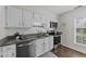 Traditional kitchen with white cabinets, subway tile backsplash, granite countertops and stainless steel appliances at 3111 Coachmans Way, Durham, NC 27705