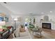 Comfortable living room featuring neutral tones, a cozy fireplace, and access to an outdoor deck at 3111 Coachmans Way, Durham, NC 27705