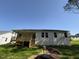 Back of house featuring a wooden deck and green grass at 325 Magnolia Run Way, Benson, NC 27504