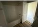 Bathroom with tub/shower combo and wood-look flooring at 325 Magnolia Run Way, Benson, NC 27504