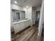 Bathroom showcasing dual vanity with granite countertop and wood-look flooring at 325 Magnolia Run Way, Benson, NC 27504