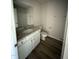 Bathroom showcasing single vanity with granite countertop and wood-look flooring at 325 Magnolia Run Way, Benson, NC 27504
