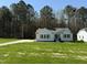 Charming single-story home featuring a well-manicured lawn and a concrete driveway at 325 Magnolia Run Way, Benson, NC 27504